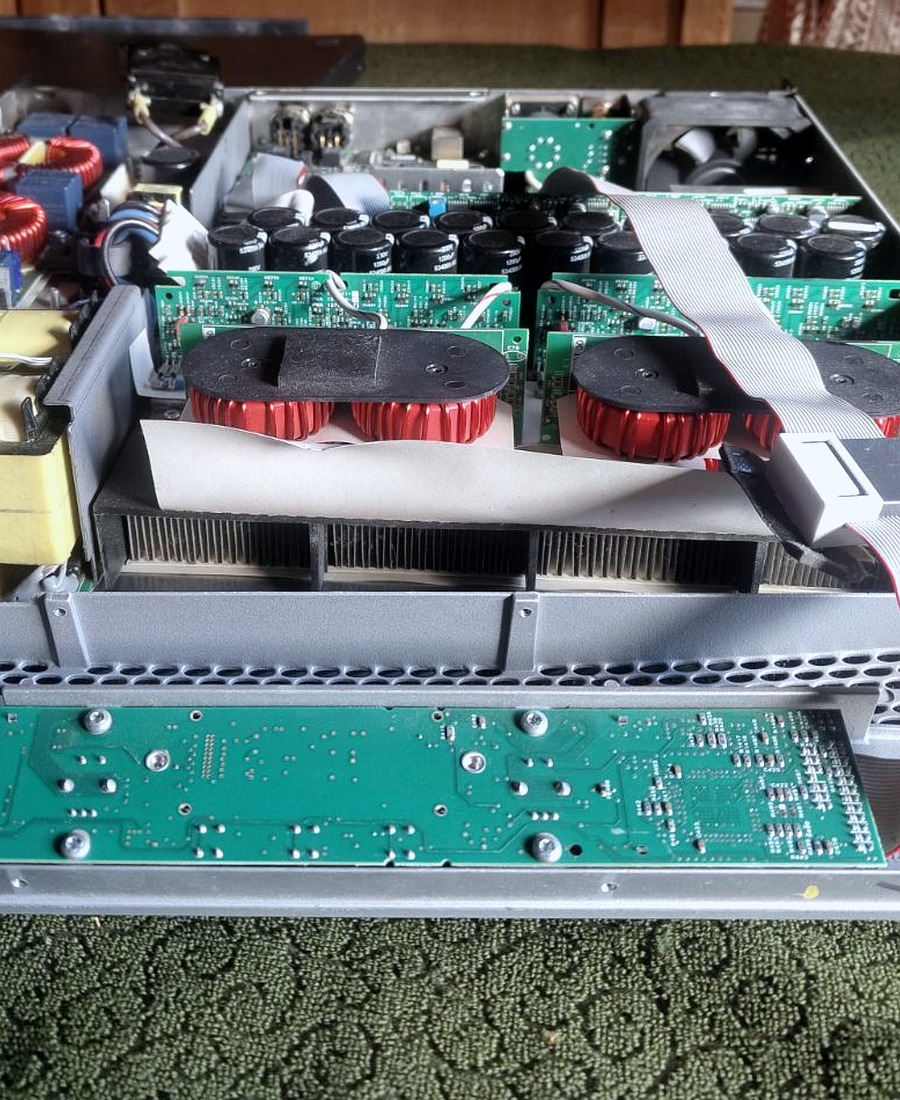 Real close-up photograph of amplifier circuit board, capacitors and transformer